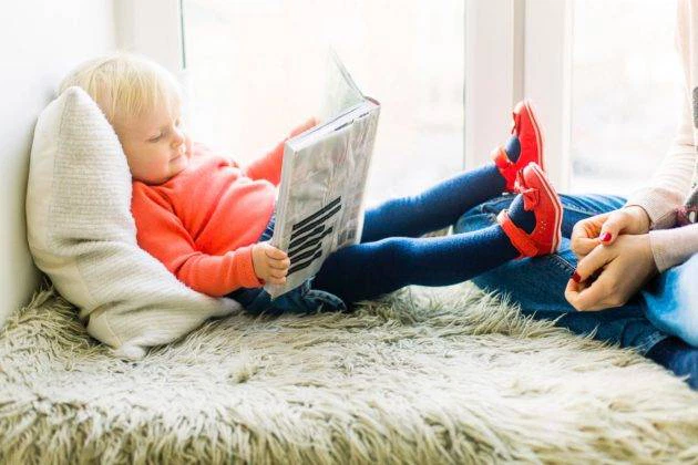 Young Boy Enjoying His Book Photo of a Child Reading a Book