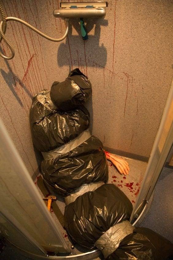 Shower with fake dead body bag for Halloween prop A pretend dead body in a bag in shower